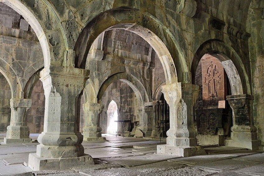 An ancient stone structure with arches and columns. 3