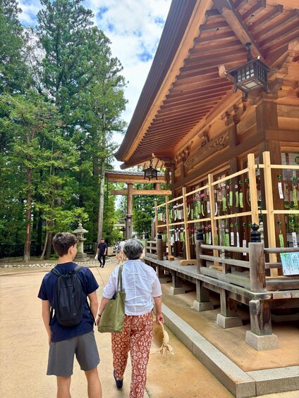 A traditional wooden structure with a sloped roof, surrounded by trees. 5