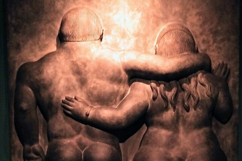 A sculpture of two figures embracing. 2