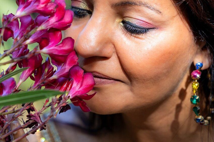 A person wearing colorful earrings and a floral accessory. 3