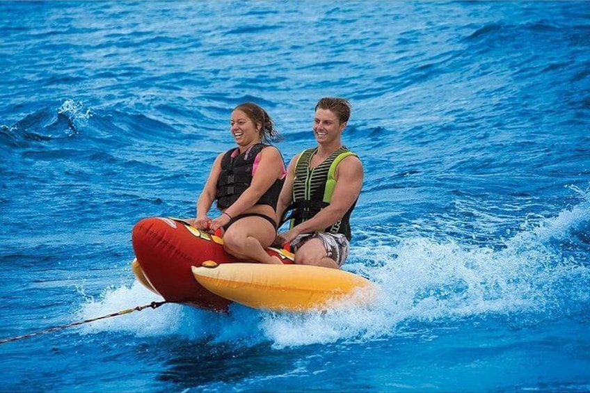 Two people on a jet ski in the ocean. 2