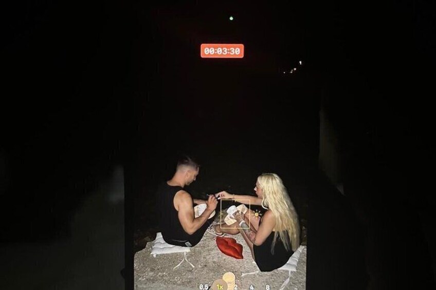 Two people sitting on the ground, possibly outdoors at night, with a timestamp indicating 00:03:30. 3