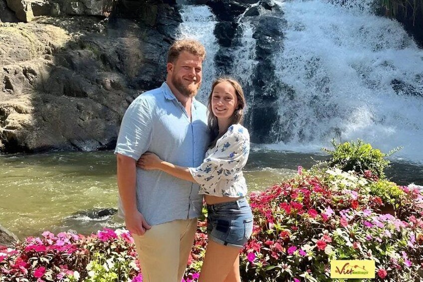 A waterfall, a couple, and colorful flowers. 3