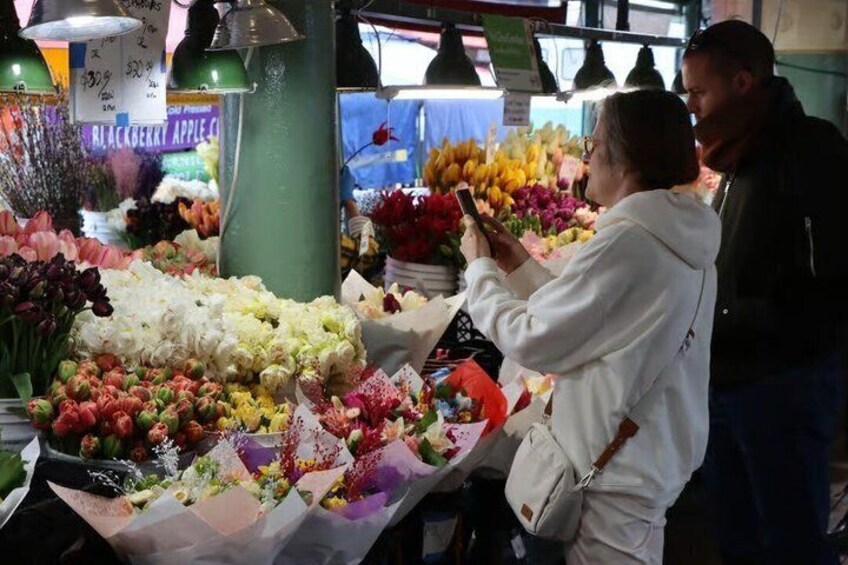 A flower market with various blooms and a sign for 'BLACKBERRY APPLE.' 2