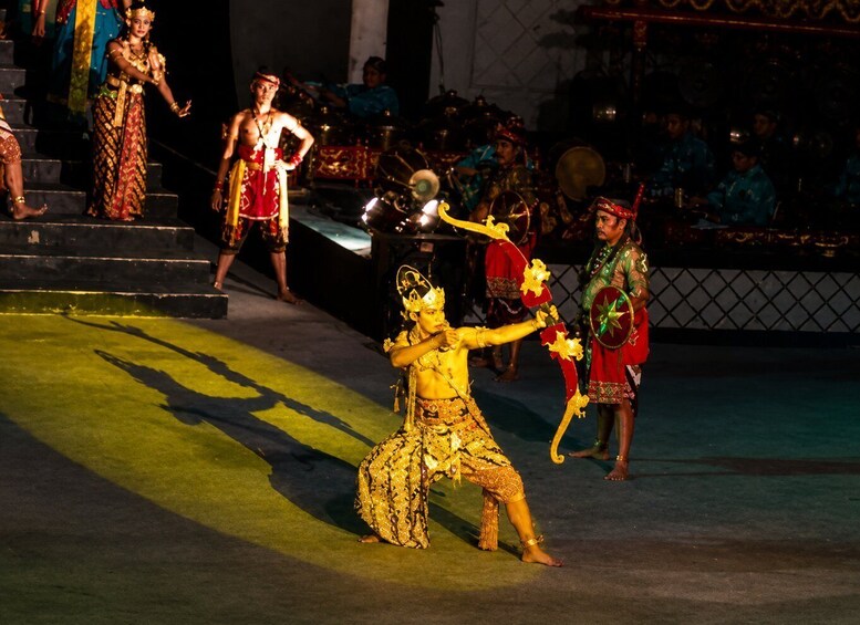 A cultural performance with dancers in traditional costumes on a stage. 2
