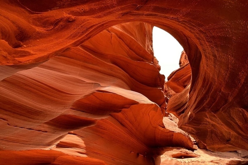 A canyon with red sandstone walls and a natural archway. 2