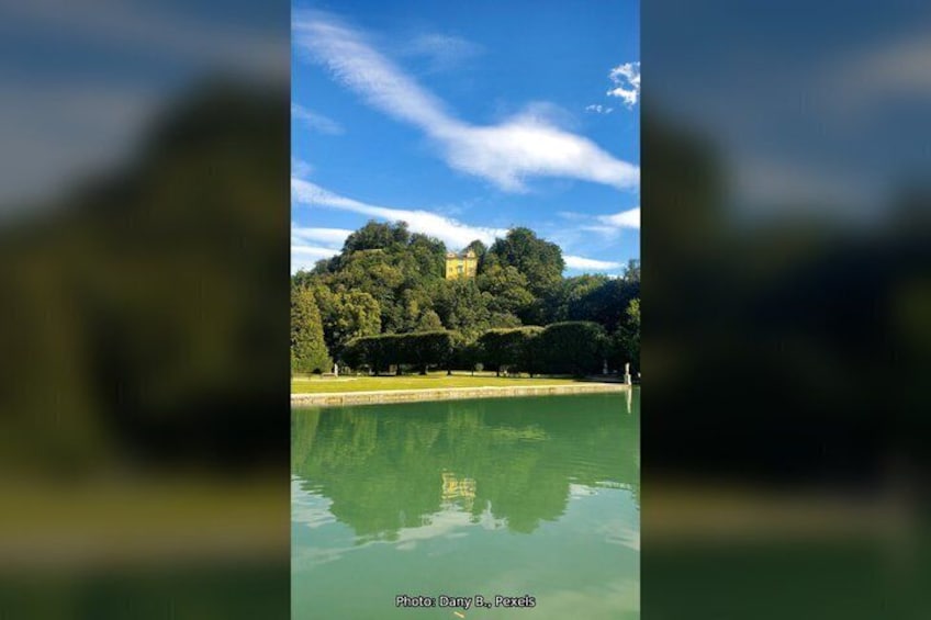 A lake with a castle on a hill, surrounded by trees. 3