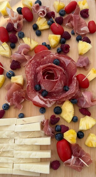 A charcuterie board with various meats, cheeses, and fruits. 3