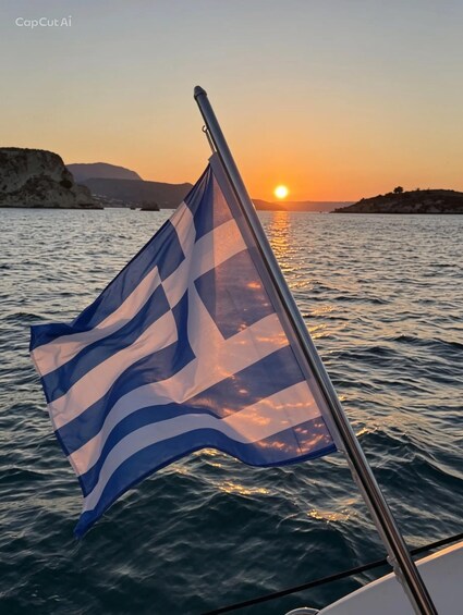 A flag on a boat with a sunset in the background. 5