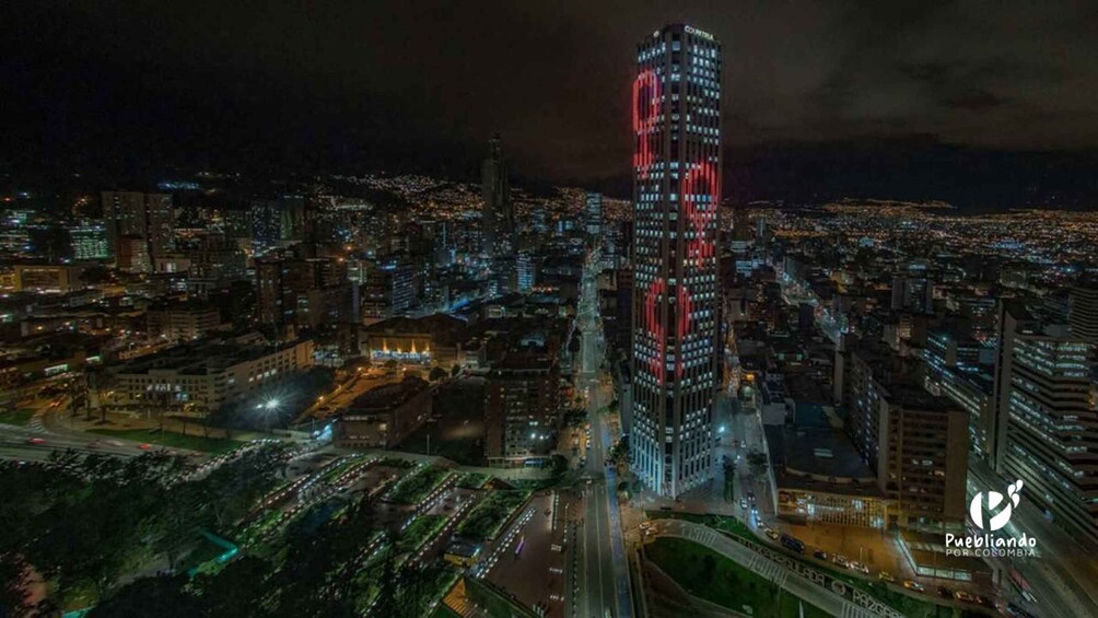 A nighttime cityscape with a prominent skyscraper featuring red lighting. 4