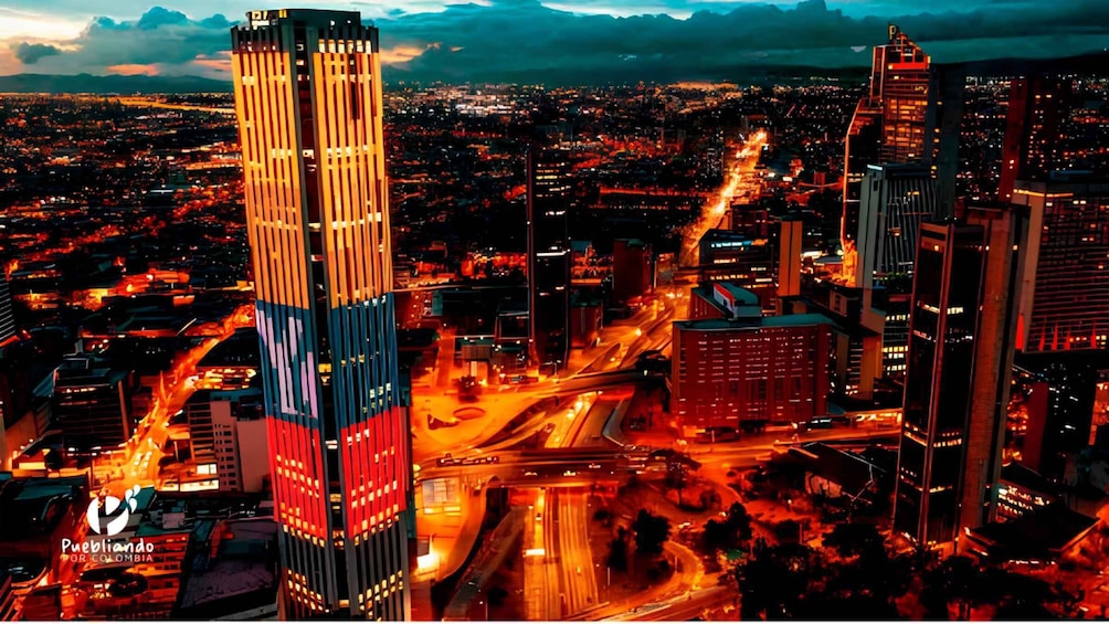 A cityscape at dusk with illuminated buildings and a prominent skyscraper. 5