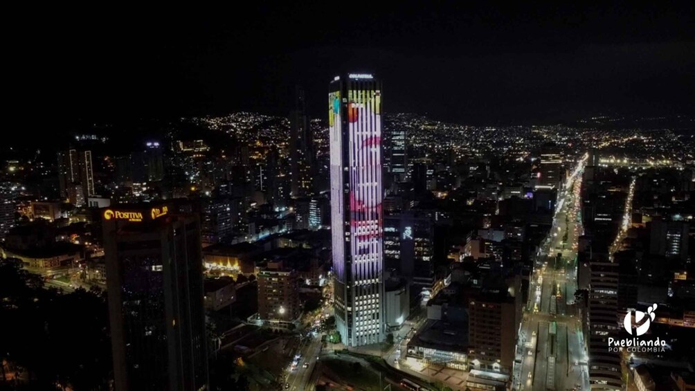 A cityscape at night with a brightly lit skyscraper featuring vertical stripes. 3