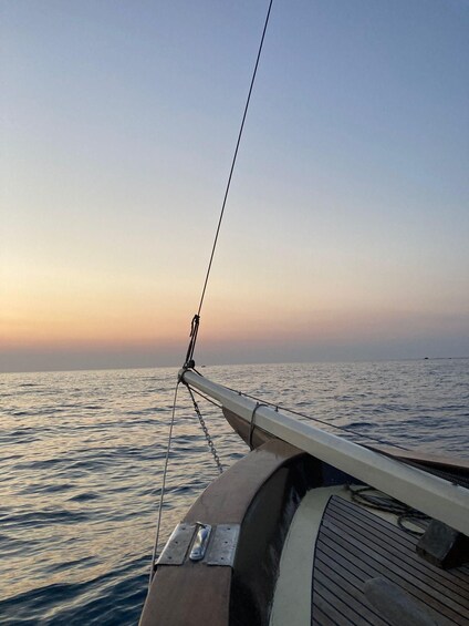 A boat's bow with a rope and a wooden deck. 1
