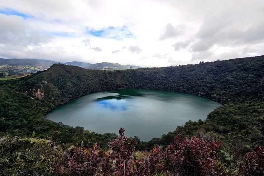 A large, circular lake surrounded by forested hills. 1