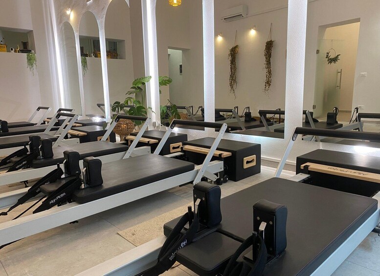 A Pilates studio with equipment and mirrors. 1