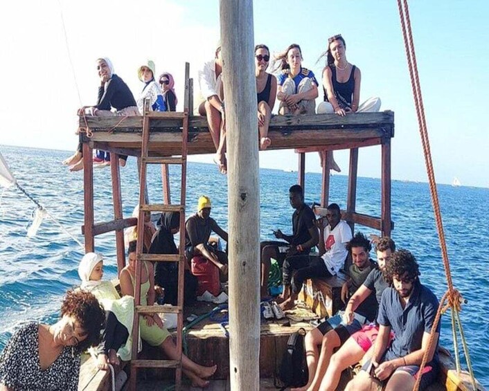 A group of people on a wooden platform on a boat in the water. 4