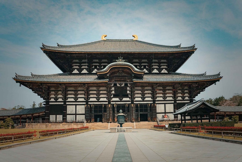 A traditional East Asian building with a symmetrical roof and ornate wooden details. 1