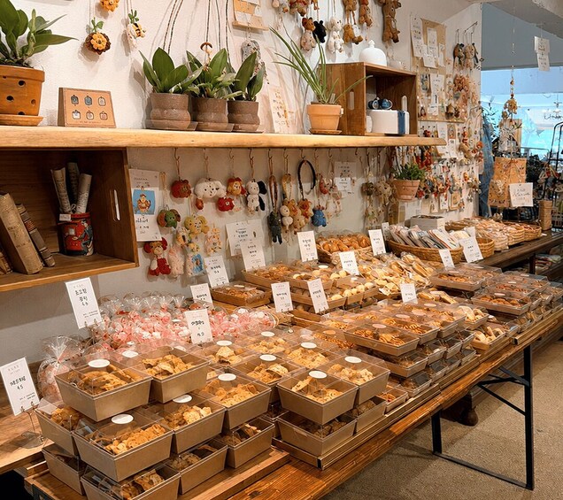 A bakery display with various baked goods and hanging decorations. 2