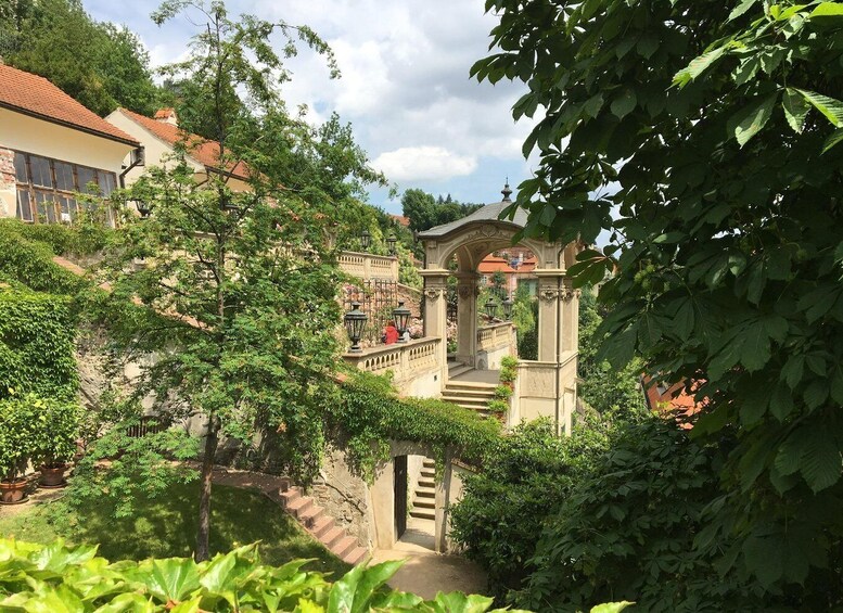 A garden with a stone staircase, a gazebo, and lush greenery. 5