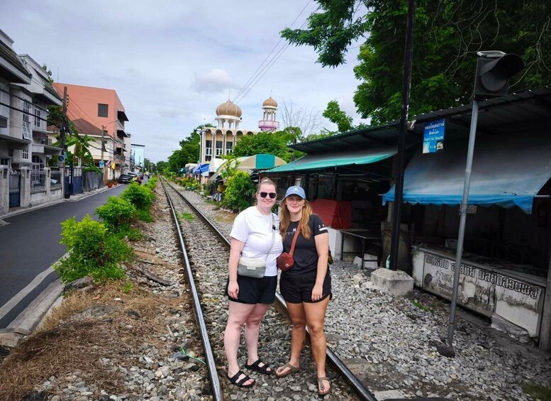 A railway track with buildings and a mosque in the background. 3