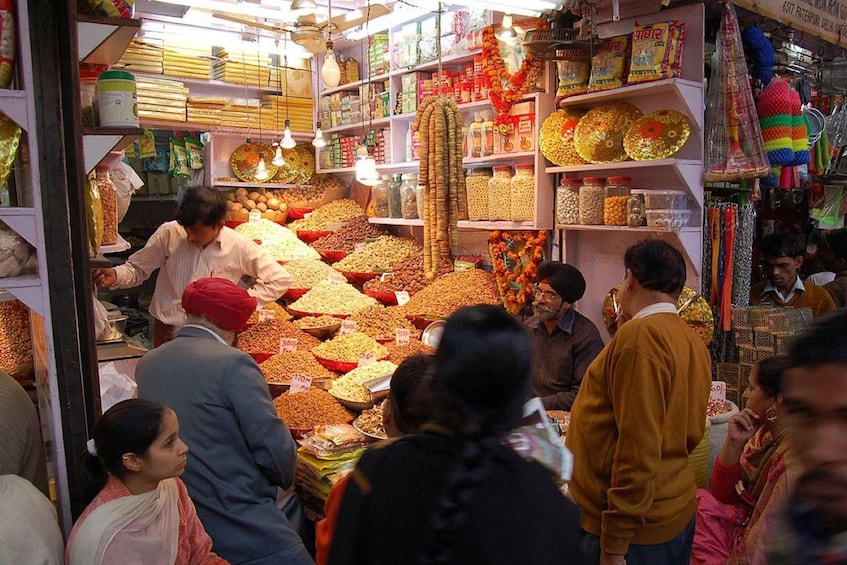 A bustling market with various food items and spices displayed on shelves and tables. 5