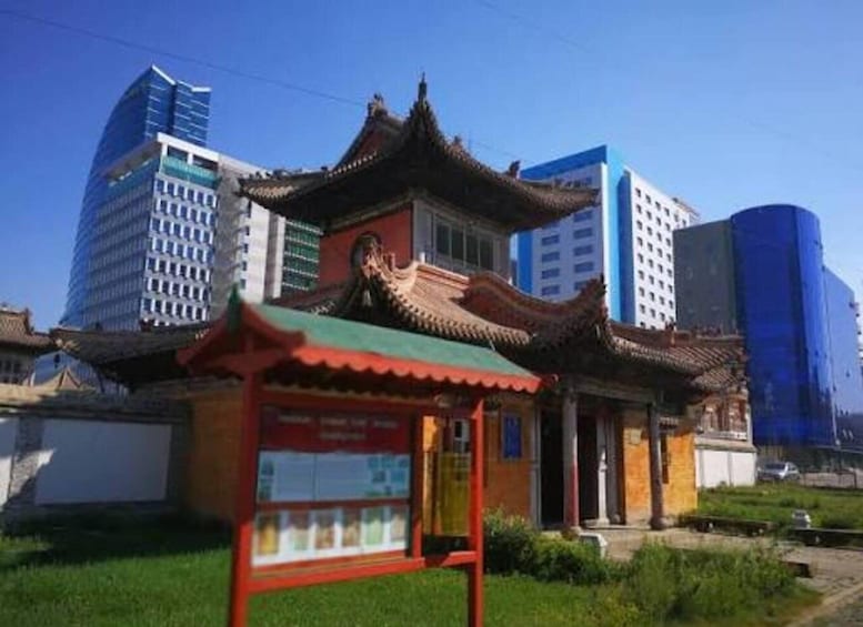 A traditional Chinese building with a red roof and a signboard in front. 1