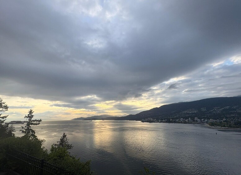 A calm lake with a cityscape in the distance, surrounded by hills. 4