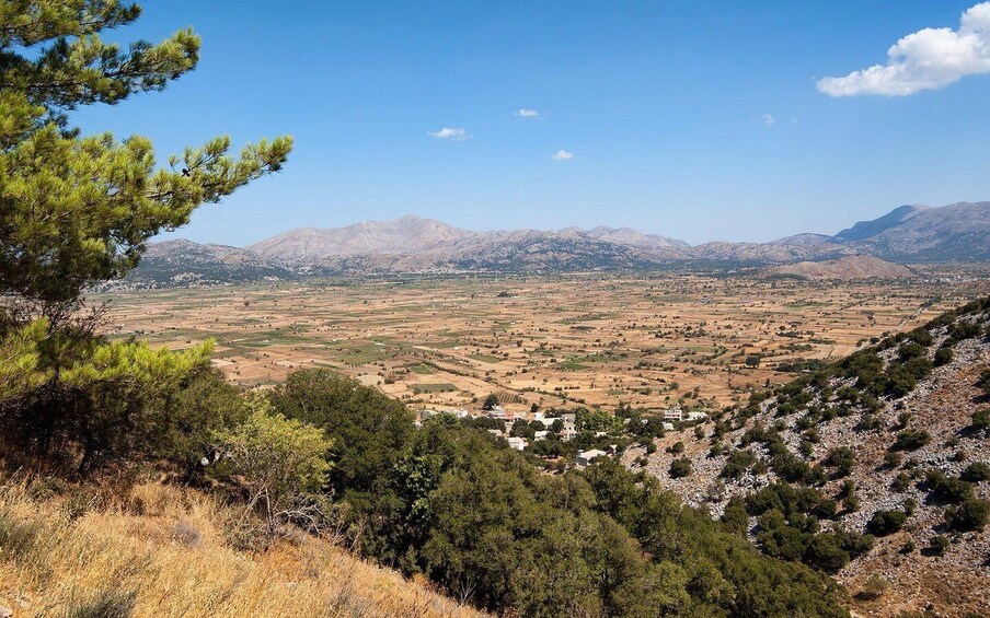 A mountainous landscape with scattered houses and fields. 4