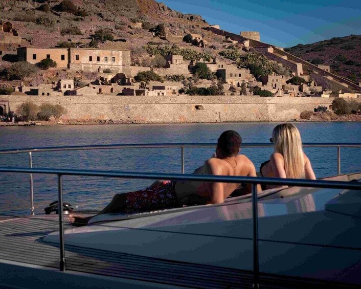 A couple on a boat overlooking a historic town by the water. 4