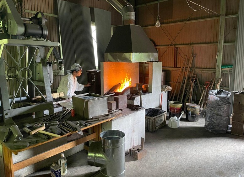 A blacksmith's workshop with a forge, anvil, and various tools. 2