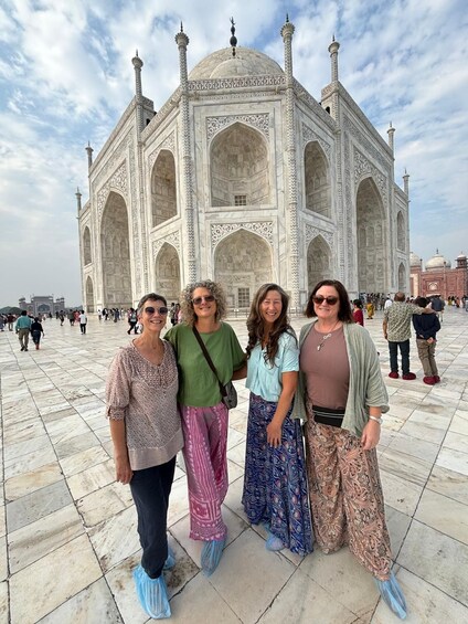 A group of people standing in front of the Taj Mahal. 3