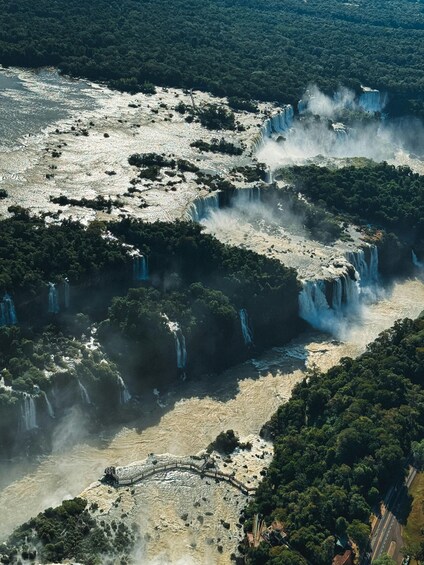 A series of waterfalls cascading through a forested landscape. 2