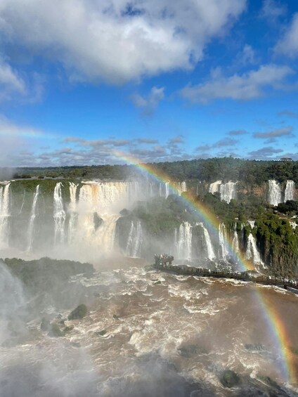 A large waterfall with a rainbow and a viewing platform. 5