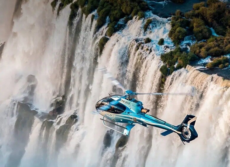 A helicopter flying over a waterfall. 3