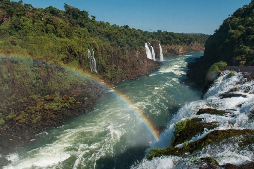 A river with multiple waterfalls and a rainbow. 4