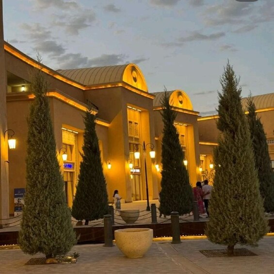 A building with a warm yellow exterior and a large central archway. 2