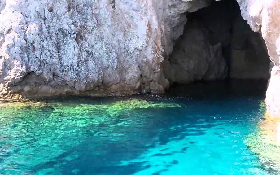 A clear blue cave entrance with rocky walls. 3