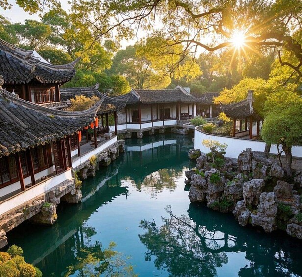 A traditional Chinese garden with a clear pond, tiled roofs, and rocky formations. 1