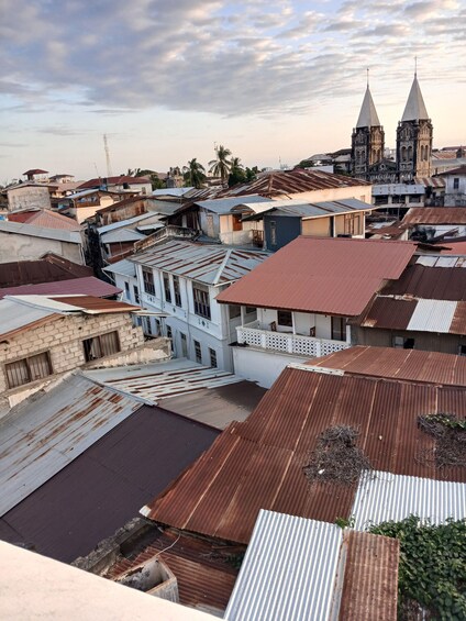 A densely packed urban area with various buildings, including a prominent church with two spires. 2