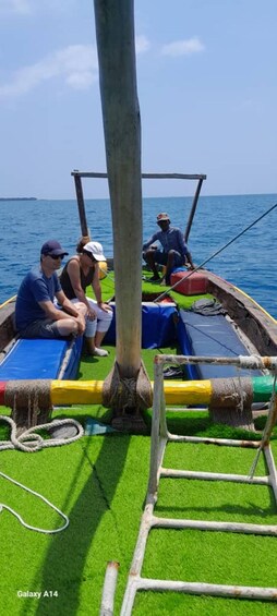 A boat with people on board, a wooden structure, and a rope. 4