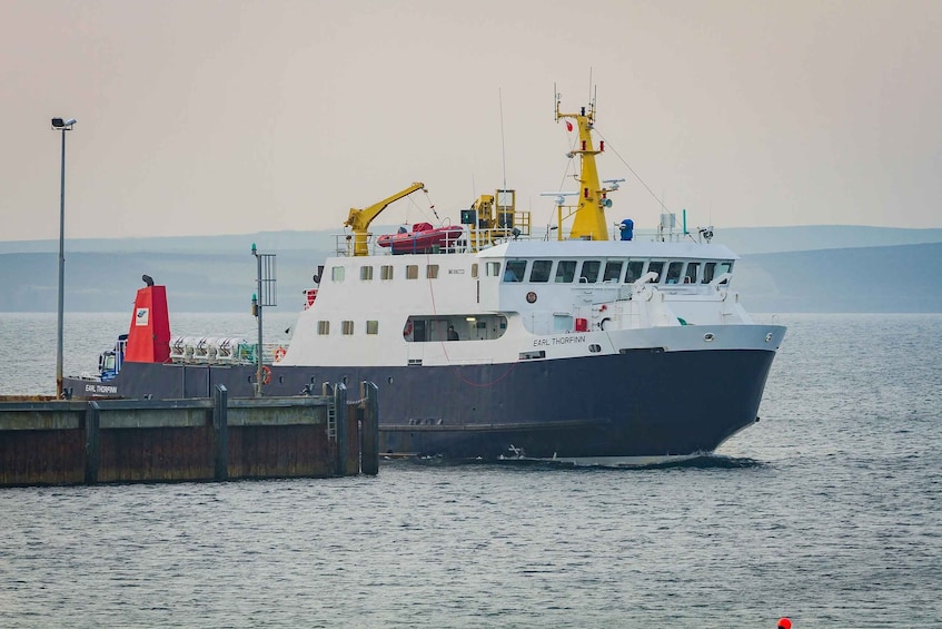 A large vessel named 'Earl Thorfinn' docked at a pier with a crane and lifeboats visible. 5