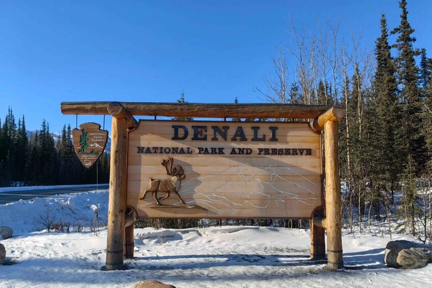 A wooden sign for Denali National Park and Preserve with a moose illustration. 3
