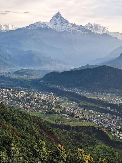 A mountainous landscape with a town nestled in the valley. 1