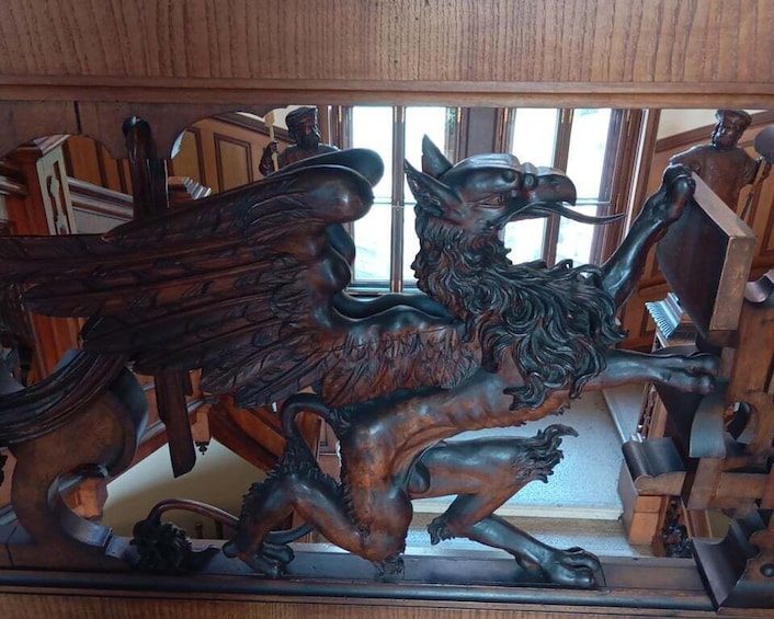 A detailed bronze sculpture of a mythical creature with wings and a lion's body. 5