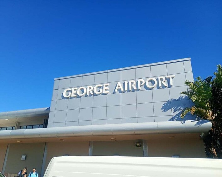 The exterior of George Airport with its name displayed prominently on the building. 1