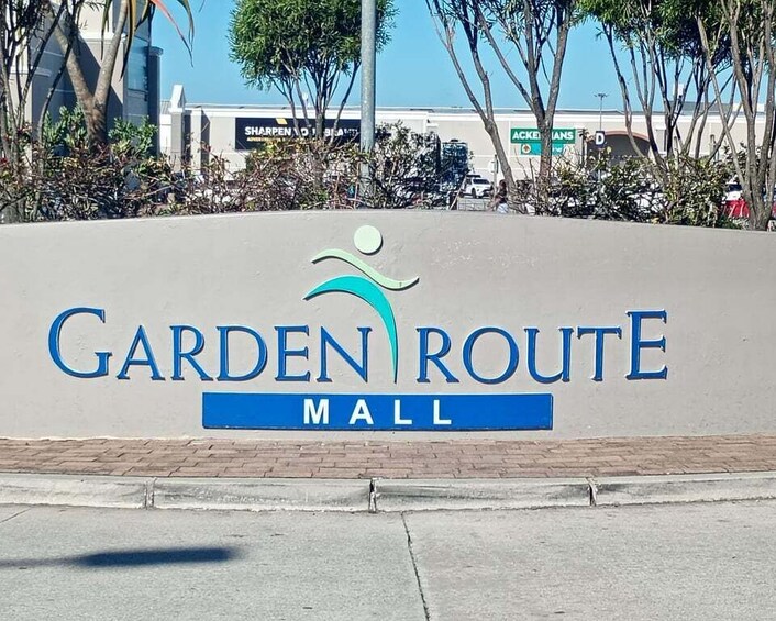 A sign for Garden Route Mall with a logo above the text. 4