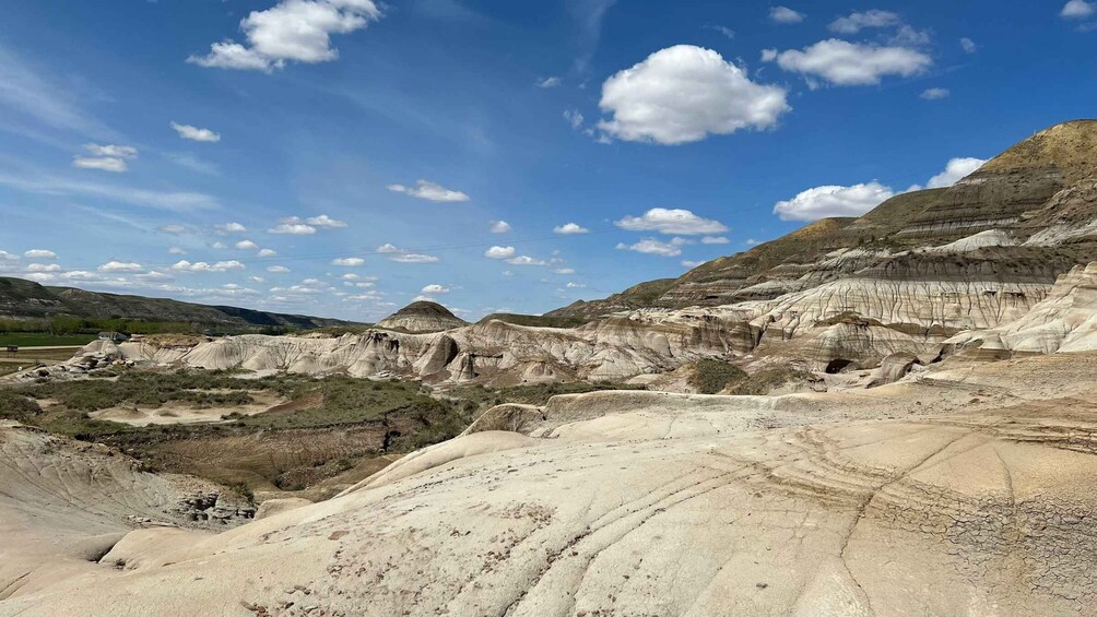 A rugged landscape with layered rock formations and a clear blue sky. 2