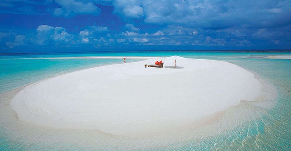 A white sandy island surrounded by turquoise waters. 1