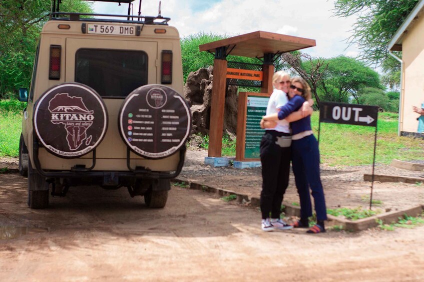 A vehicle with a 'KITANO' logo, a sign reading 'DRANGCITE NATIONAL PARK,' and a sign indicating 'OUT' direction. 4