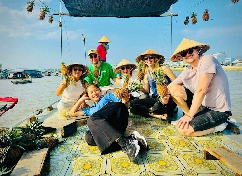 A group of people on a boat with pineapples. 1